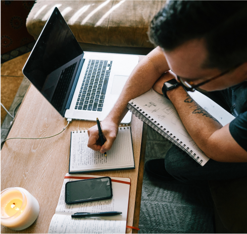 Polaroid of strategist taking notes at his computer
